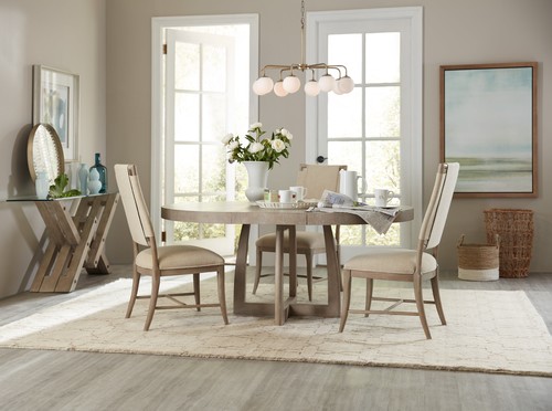 Rubberwood dining table with three chairs in a well-lit dining area.
